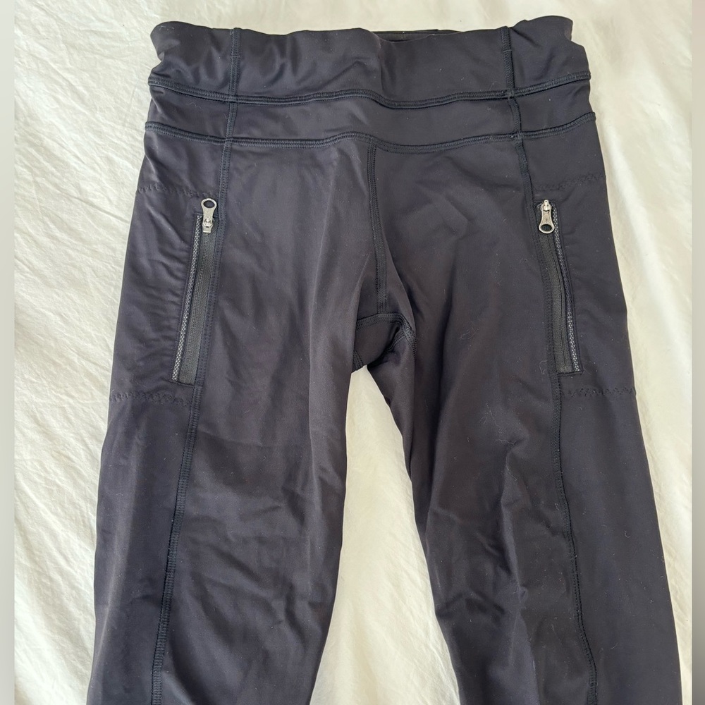 Lightly worn black Lululemon leggings with zippers, size 4!
